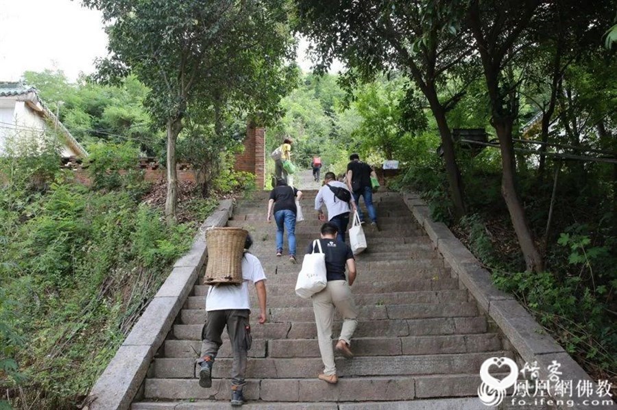 长安区佛教协会、慧海公益工作团队与终南山圭峰寺常住居士一起将端午礼包背上山(图片来源:凤凰网佛教)